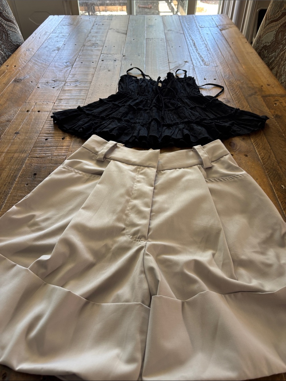 Low Classic tan  Bermuda Shorts and black spaghetti  shirt. Shorts retail $340.